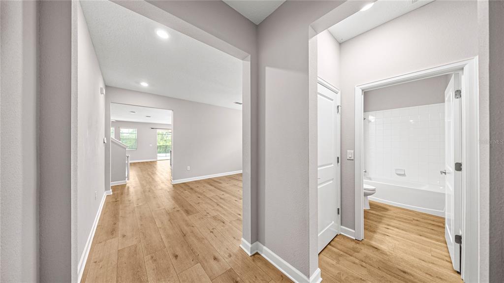 A blue front door is set in a white stucco entryway with a vertical address sign — 10264 LOVE STORY STREET, WINTER GARDEN, FL