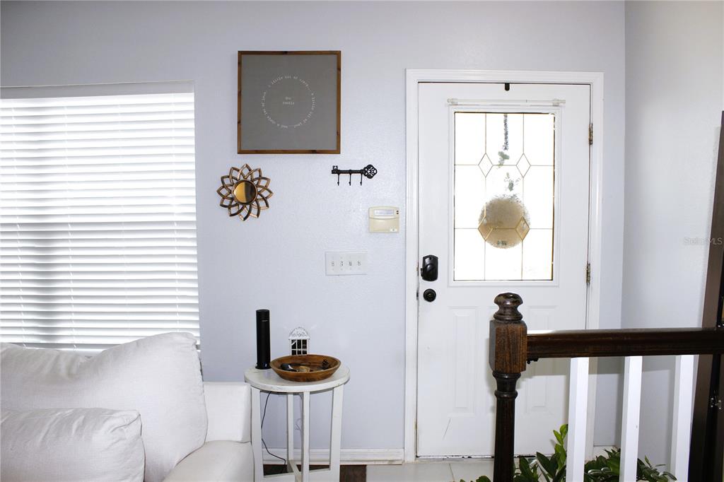 A living room features a white sectional sofa, a round textured coffee table, and hardwood flooring — 5307 TERRAZA COURT, TEMPLE TERRACE, FL