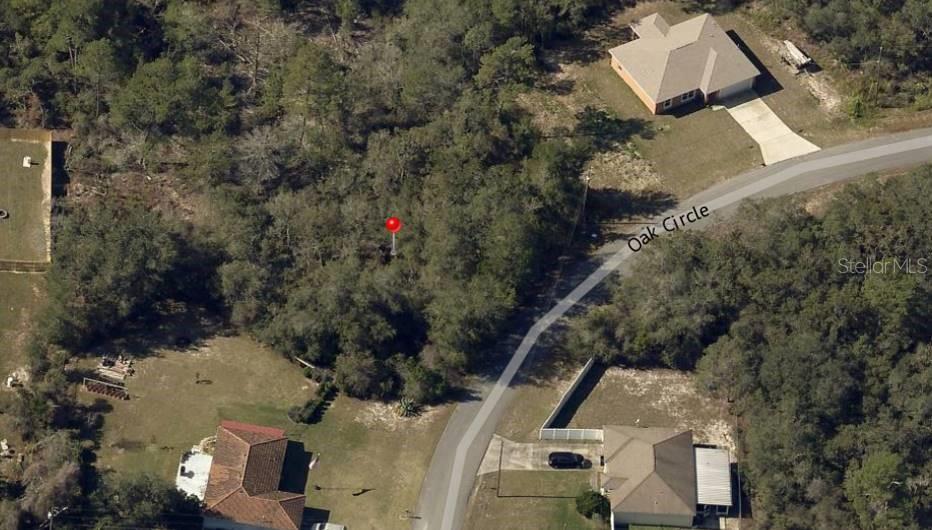 An aerial view shows a wooded vacant lot marked with a red pin on Oak Circle — Lot 9 OAK CIRCLE, OCALA, FL