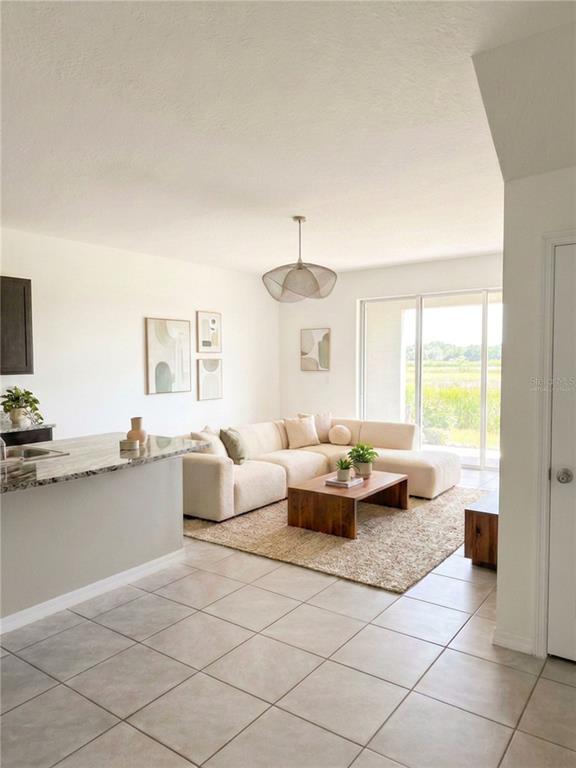 A view through a doorway into a bedroom with gray walls and gray carpeting — 5254 DRAGONFLY DRIVE, WILDWOOD, FL