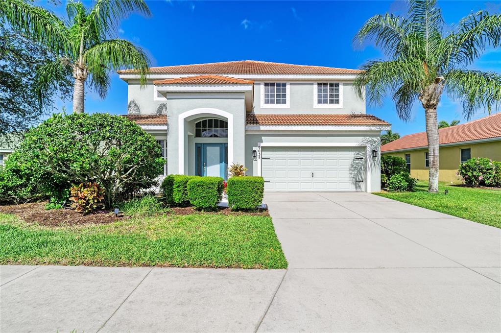 A two-story house with a light gray exterior, a tile roof, and a two-car garage — 9035 WILLOWBROOK CIRCLE, BRADENTON, FL