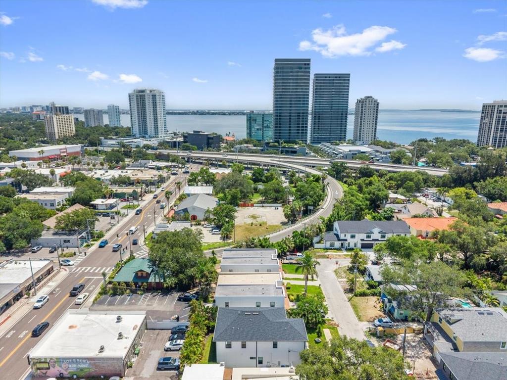 An aerial view shows a city street, residential neighborhood, and high-rise buildings near the water — 3203 W SANTIAGO STREET UNIT B, TAMPA, FL