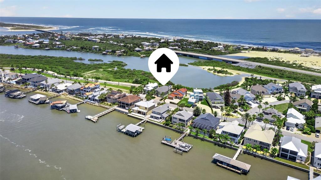 An aerial view shows waterfront houses with private docks along a coastal inlet — 9138 JUNE LANE, ST AUGUSTINE, FL
