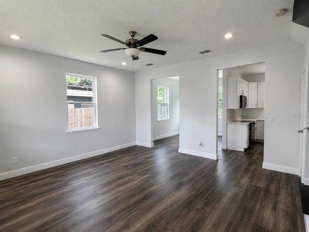 A two-story suburban house with a beige stucco exterior, a garage, and a front lawn — 3778 MARTIN STREET, ORLANDO, FL