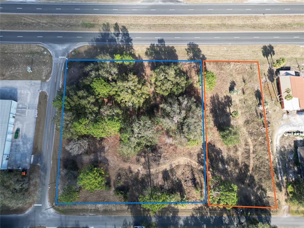 Aerial view of two adjacent vacant lots bordered by a highway and a side road — 12441 SE 72ND AVENUE, BELLEVIEW, FL