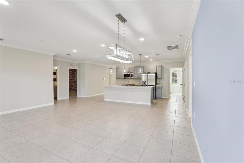 A spacious open-concept kitchen and living area with tile flooring and a large island — 2410 PARK AVENUE, INDIAN LAKE ESTATES, FL