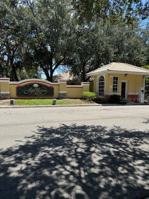 The entrance to Lake Marion Resort features a gated guardhouse and a decorative community sign — 689 LAKE MARION GOLF RESORT, KISSIMMEE, FL