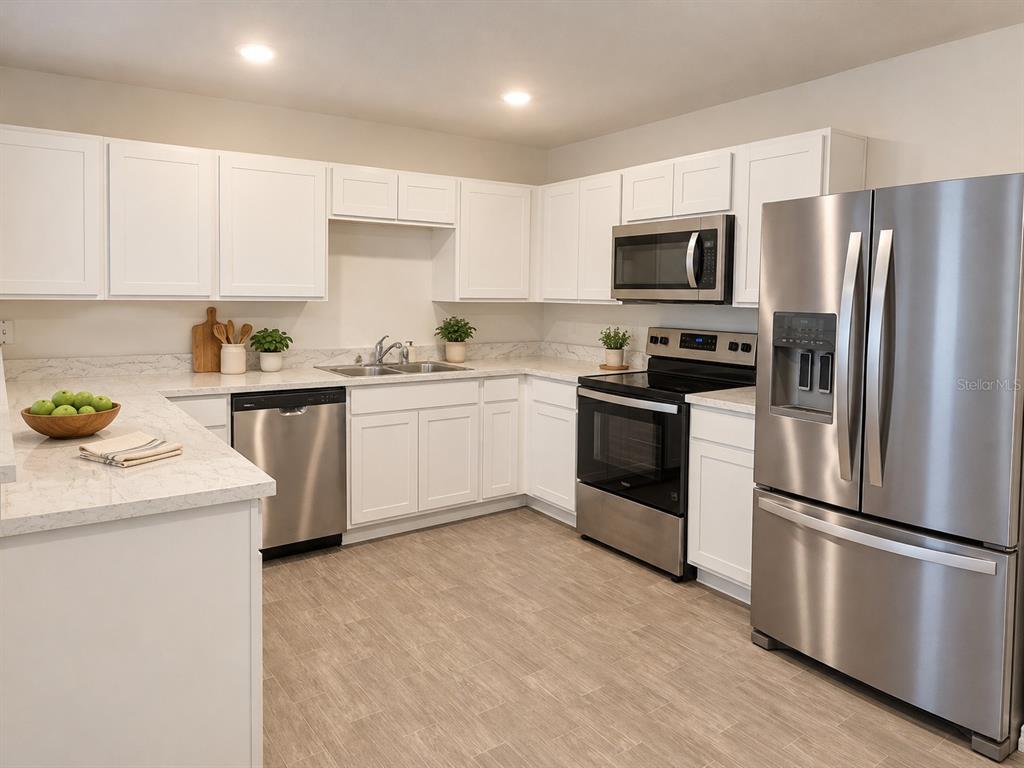 A kitchen with white cabinets, stainless steel appliances, and light-colored countertops — 53 ORCHID COURT, POINCIANA, FL