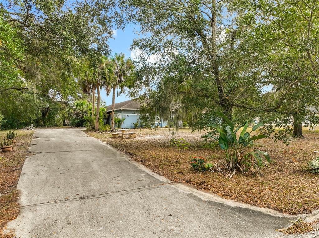 An entryway features white walls, a white front door with sidelights, and wood-look tile flooring — 1833 CROWLEY CIRCLE, LONGWOOD, FL