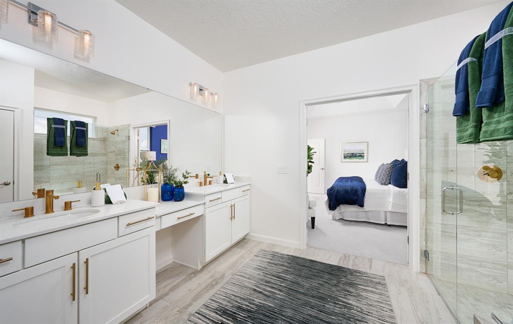 A bathroom with a double vanity, white cabinets, gold hardware, and a glass-enclosed shower — 2248 SIRENA LANE, MOUNT DORA, FL