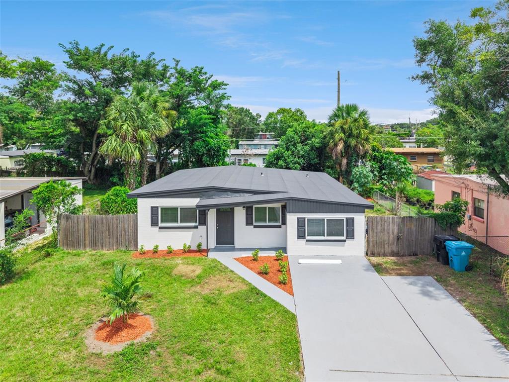 A single-story house with a gray roof, white exterior, and a concrete driveway — 2821 W AMELIA STREET, ORLANDO, FL