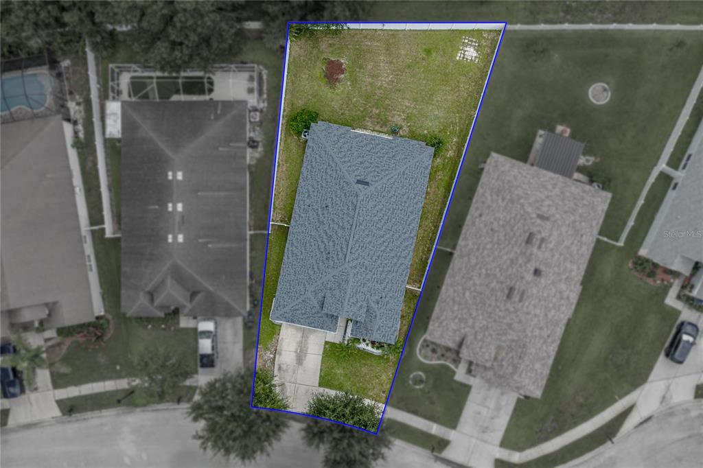 An aerial view shows a single-family home with a fenced backyard on a suburban lot — 34455 CLIFFCREEK COURT, WESLEY CHAPEL, FL