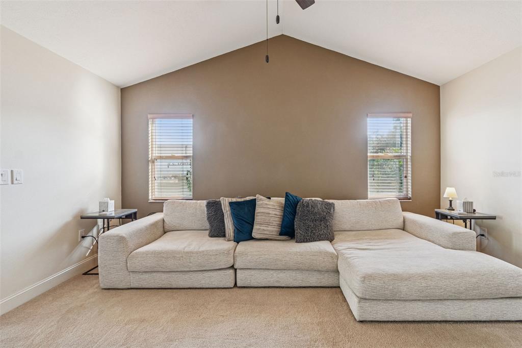 A two-story townhouse with a light green exterior, a driveway, and a single-car garage — 4181 CENTER POINTE CIRCLE UNIT 91B, SARASOTA, FL