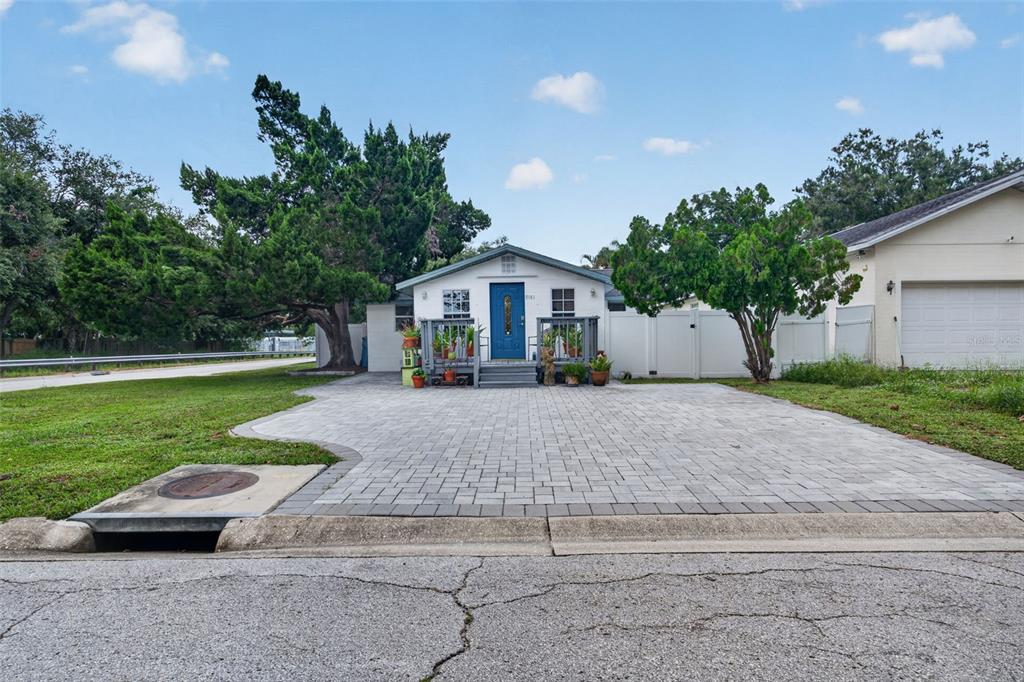 A single-story house with a blue front door, a paved driveway, and a small porch — 5161 RENA STREET N, ST PETERSBURG, FL