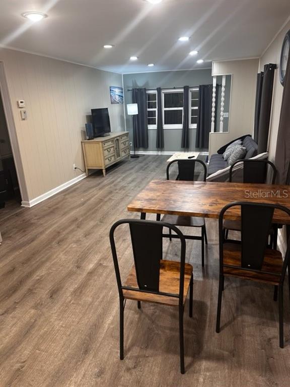 A dining area with a wooden table and chairs opens into a living room space — 530 SUN UP STREET, NORTH FORT MYERS, FL