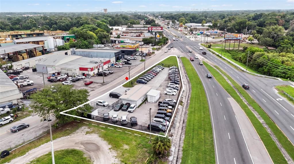 An aerial view shows a triangular commercial lot with a small building and parking area — 7116 ROSE AVENUE, ORLANDO, FL