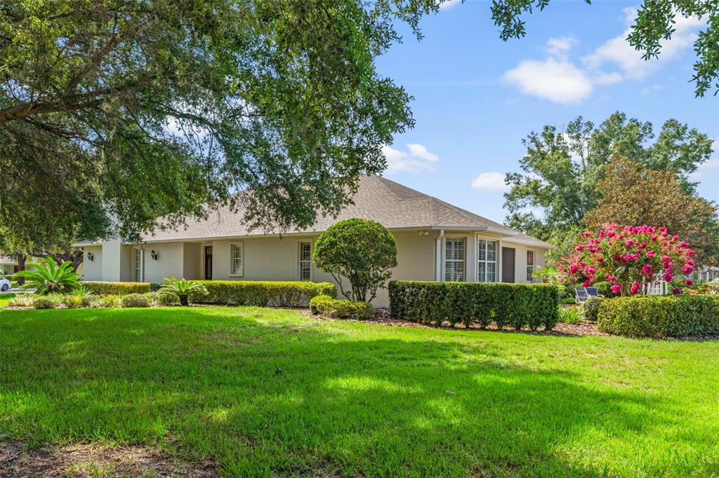 A single-story house with a tan exterior, a shingled roof, and manicured landscaping — 6264 W GLYNBORNE LOOP, CRYSTAL RIVER, FL