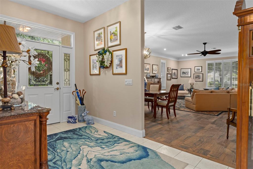 A foyer with a blue patterned rug leads into an open-concept dining and living area — 6264 W GLYNBORNE LOOP, CRYSTAL RIVER, FL