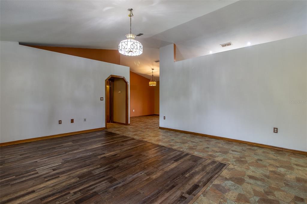 A room features a brick fireplace, a brick bar with a wood top, and dark walls — 7115 SW 80TH AVENUE, OCALA, FL