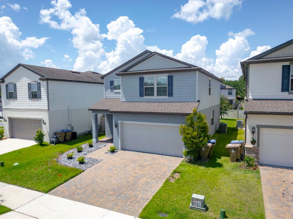 An exterior view of a two-story suburban house with a paved driveway and garage — 2704 VISTA VERDE LANE, KISSIMMEE, FL
