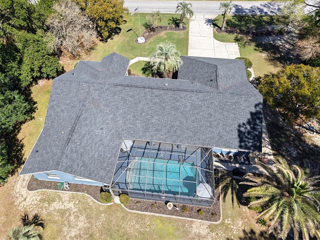 A single-story house with a gray exterior, dark roof, and a paved driveway sits outdoors — 2298 W PINE RIDGE BOULEVARD, BEVERLY HILLS, FL