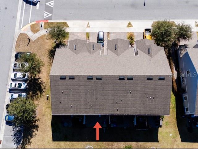 This is an aerial view of a multi-unit townhouse building with an attached parking area — 6989 TUSSILAGO WAY, ORLANDO, FL