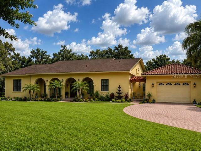 An aerial view shows a house with a brown roof, a detached garage, and walkways — 4020 N WILDER ROAD, PLANT CITY, FL