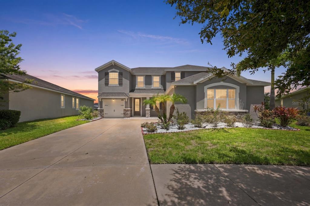 An aerial view shows a two-story house with a pond in the backyard — 10708 PLANER PICKET DRIVE, RIVERVIEW, FL