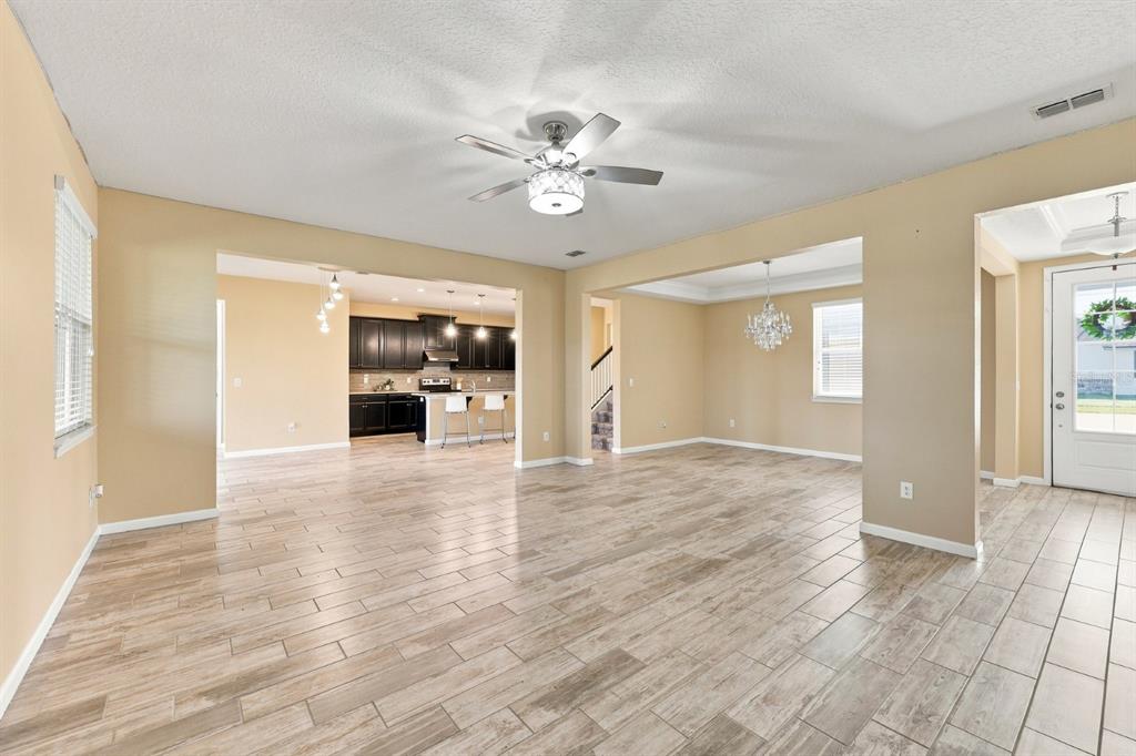 An aerial view shows a suburban house with a backyard overlooking a large pond — 10708 PLANER PICKET DRIVE, RIVERVIEW, FL