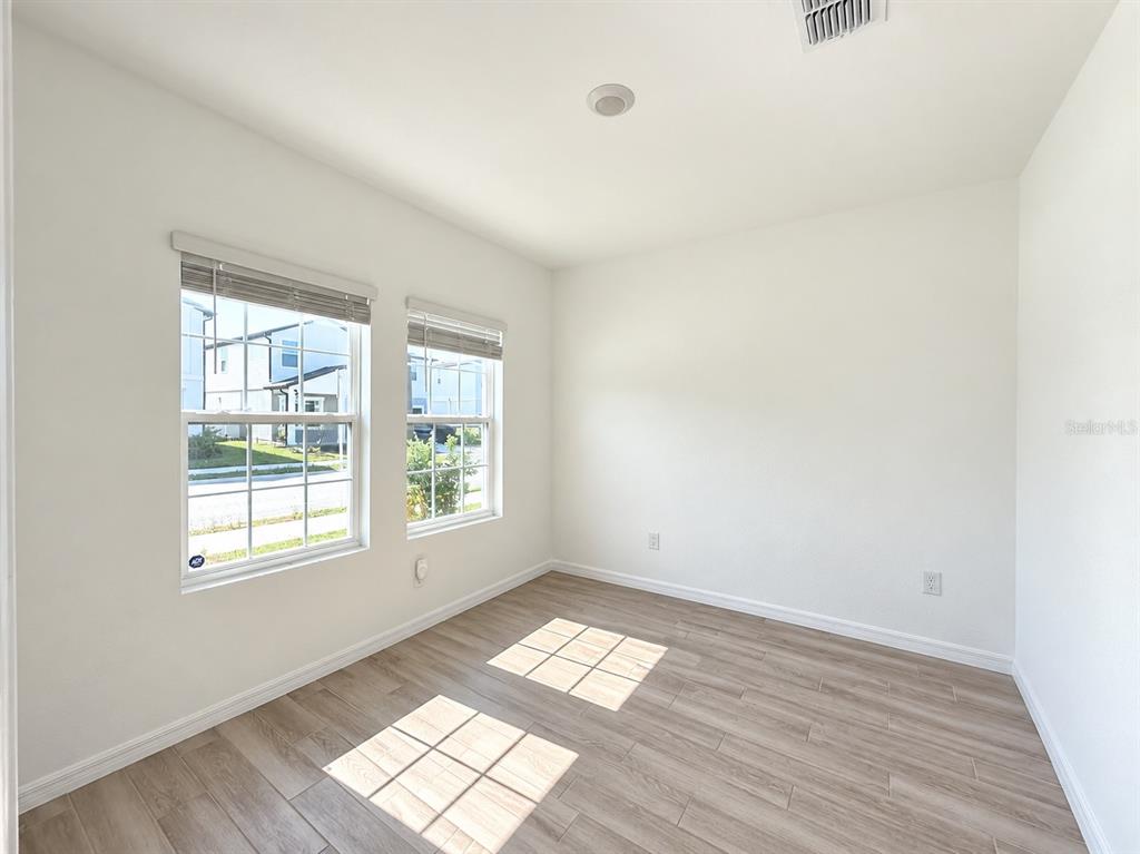 A carpeted hallway and landing area with white walls and several interior doors — 2077 DERWENT DRIVE, DAVENPORT, FL