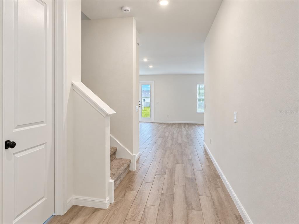 An empty room with gray carpet, white walls, and two windows — 2077 DERWENT DRIVE, DAVENPORT, FL