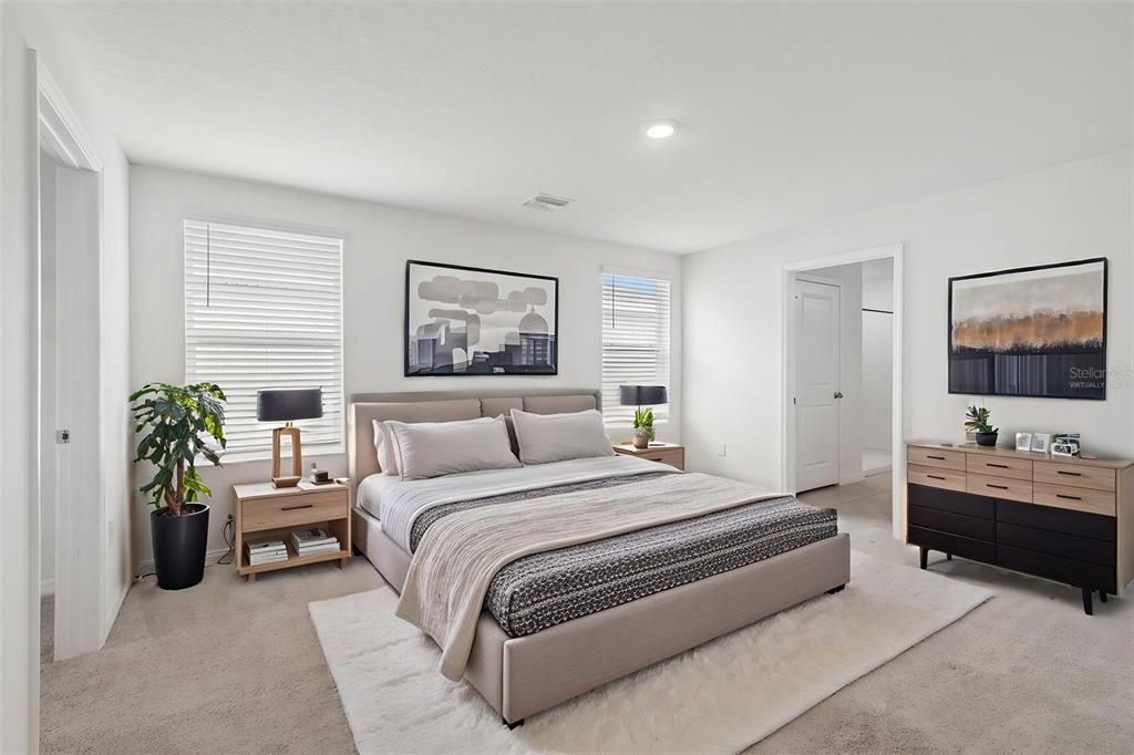 A dark gray front door is centered on a covered concrete porch with landscaping nearby — 5254 ROCKY COAST PLACE, PALMETTO, FL
