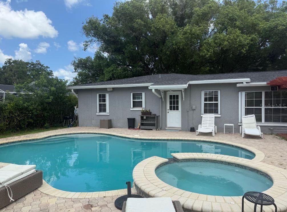 A gray house with a pool and hot tub in the backyard — 3776 23RD AVENUE N, ST PETERSBURG, FL