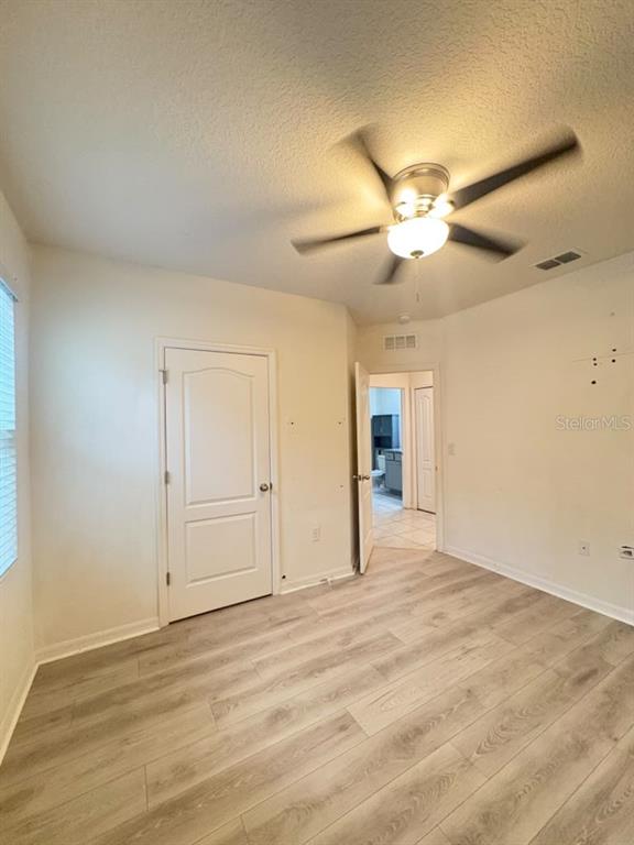 A small room with light wood-look flooring, a ceiling fan, and a window — 329 WINGED ELM DRIVE, DEBARY, FL