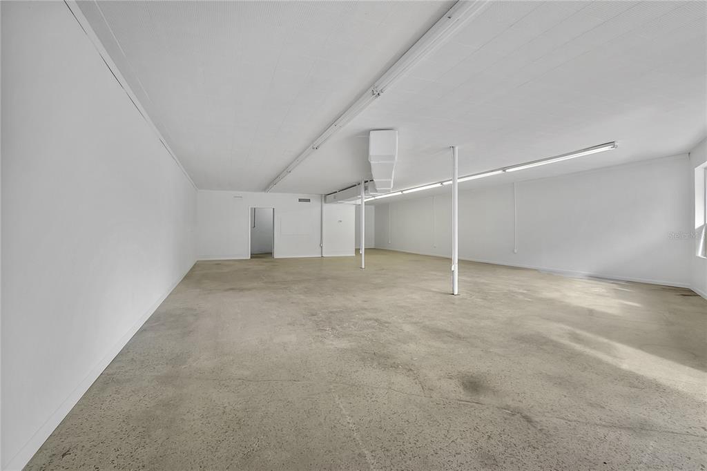 An empty commercial space features white walls, a drop ceiling, and a concrete floor — 5818 SAINT AUGUSTINE ROAD, JACKSONVILLE, FL