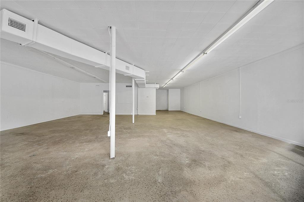 An empty commercial space with a concrete floor, white walls, and a drop ceiling — 5818 SAINT AUGUSTINE ROAD, JACKSONVILLE, FL