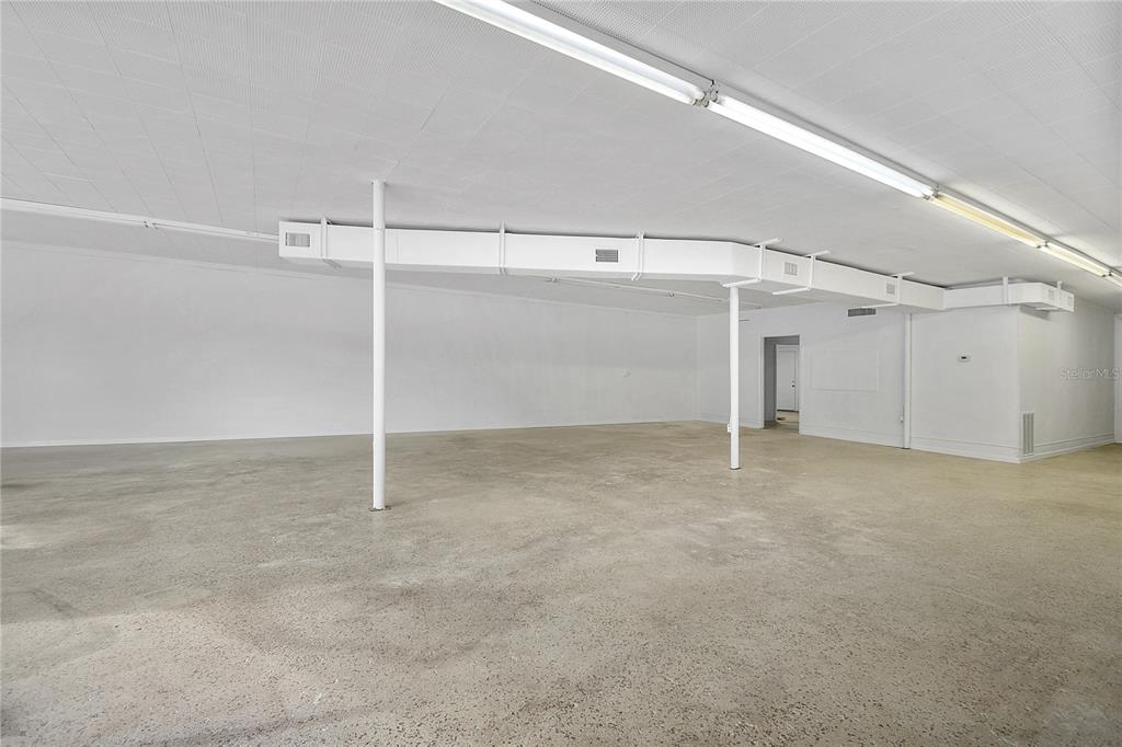 An unfinished utility room features concrete flooring, white walls, and an exposed HVAC unit — 5818 SAINT AUGUSTINE ROAD, JACKSONVILLE, FL