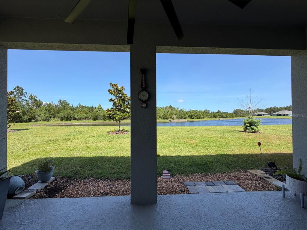 A single-story house features a paved driveway, a two-car garage, and stone veneer accents — 85 HUNTINGTON PLACE, ORMOND BEACH, FL