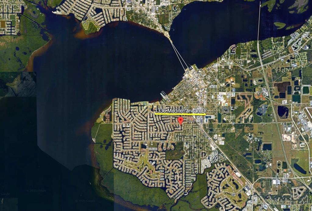 This is a satellite map view showing a residential neighborhood located along a coastline — 1336 MEDITERRANEAN DRIVE, PUNTA GORDA, FL