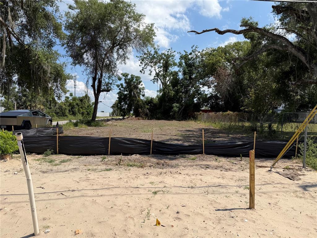 A vacant, cleared lot features a silt fence and a parked vehicle in the background — 3504 HOGSHEAD ROAD, APOPKA, FL