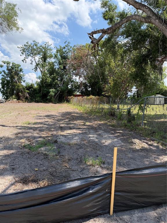 A vacant, sandy residential lot features a silt fence and mature trees along the perimeter — 3504 HOGSHEAD ROAD, APOPKA, FL