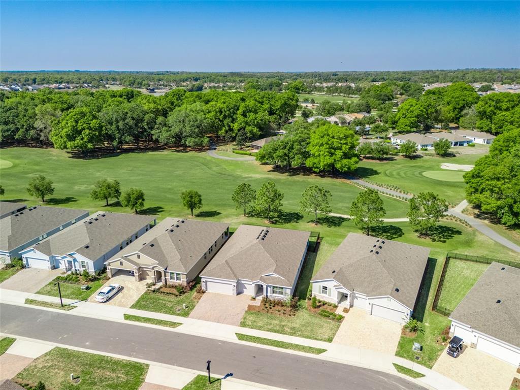 An aerial view shows a row of suburban houses bordering a golf course — 4982 NW 39TH LOOP, OCALA, FL