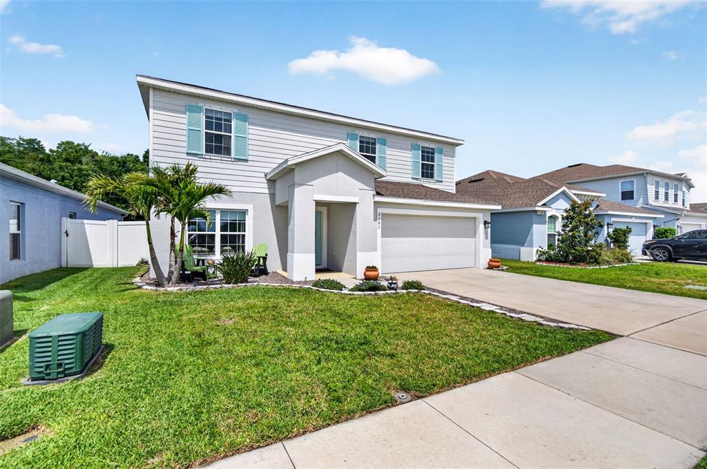 A two-story suburban house with light gray siding, a front porch, and a concrete driveway — 2161 BRANDING IRON COURT, NEW PORT RICHEY, FL