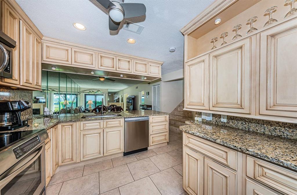 A two-story townhouse exterior features a palm tree, a covered carport, and a grassy lawn — 6260 SUN BOULEVARD UNIT 1, ST PETERSBURG, FL
