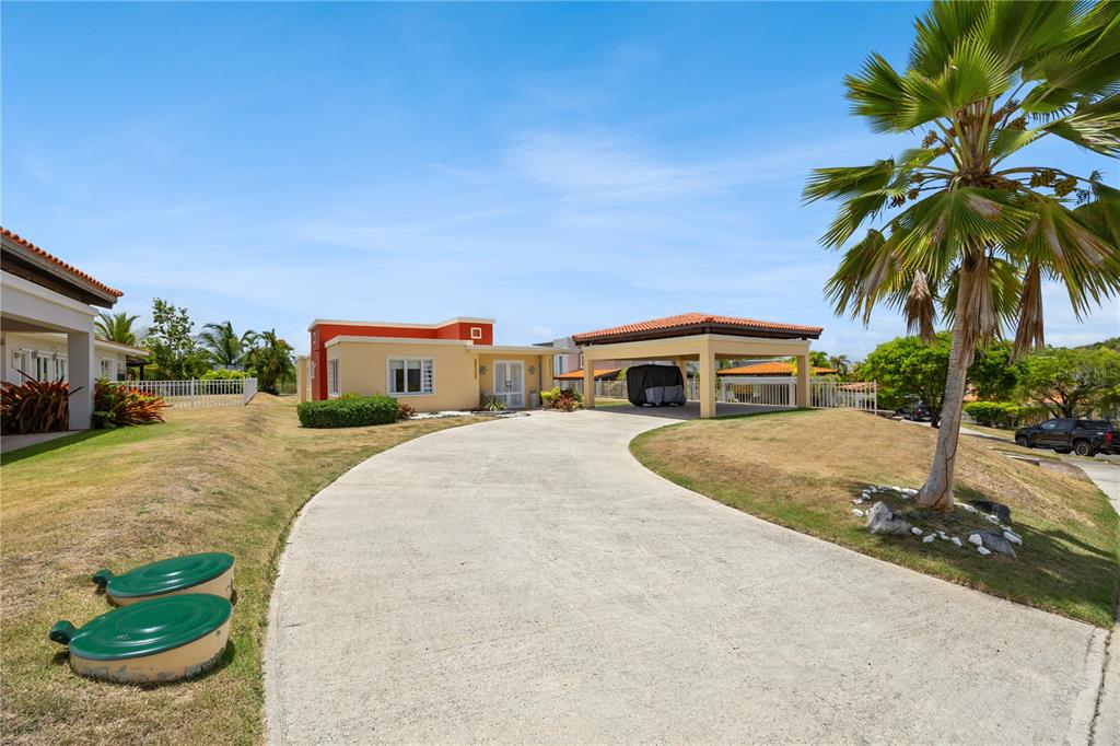 An aerial view shows a residential lot with a house under construction and detached garages — 106 MORNING DEW G-14, SUNRISE AT PALMAS DEL MAR, HUMACAO, PR
