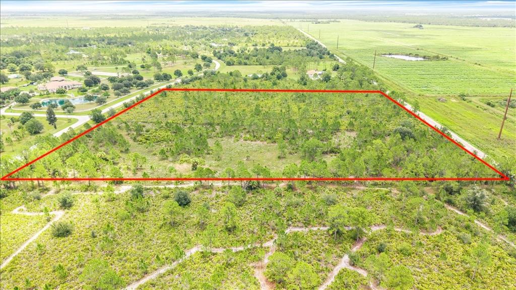 An aerial view shows a rectangular plot of land outlined in red amidst rural vegetation — 3601 HIDDEN VALLEY CIRCLE, PUNTA GORDA, FL