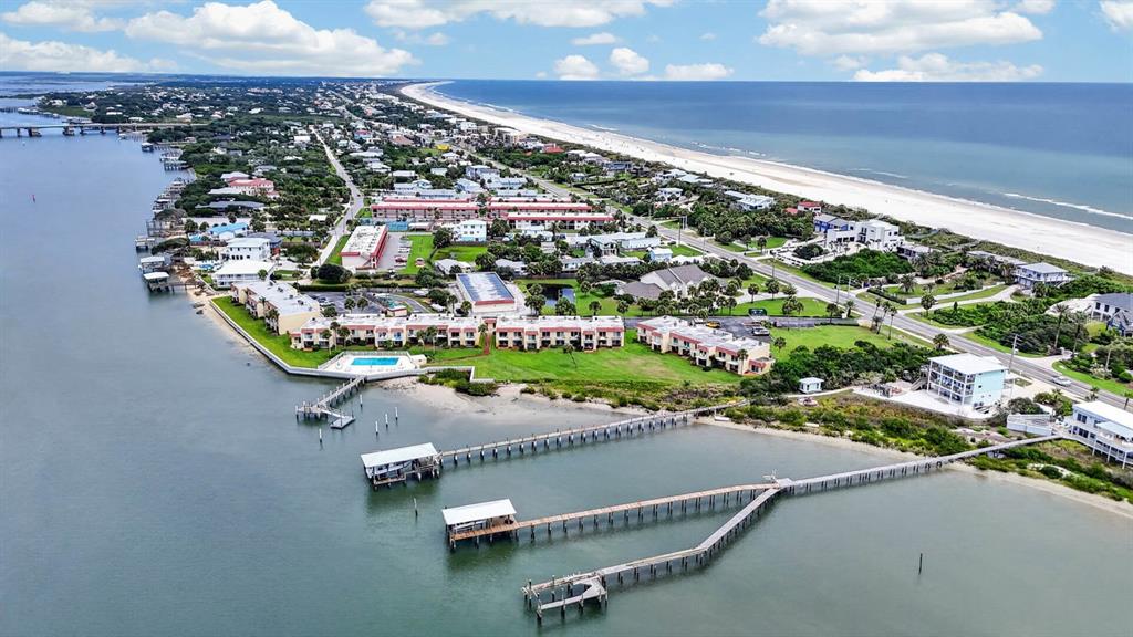 Aerial view of a coastal residential complex with multiple docks extending into the water — 7265 A1A S UNIT B8, ST AUGUSTINE BEACH, FL