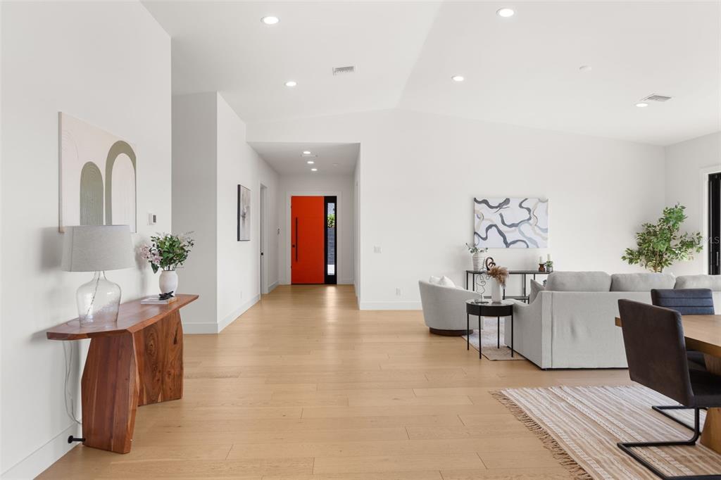 A modern single-story house with white stucco, wood-slat siding, and a paved driveway — 930 EAST BOULEVARD, WINDERMERE, FL