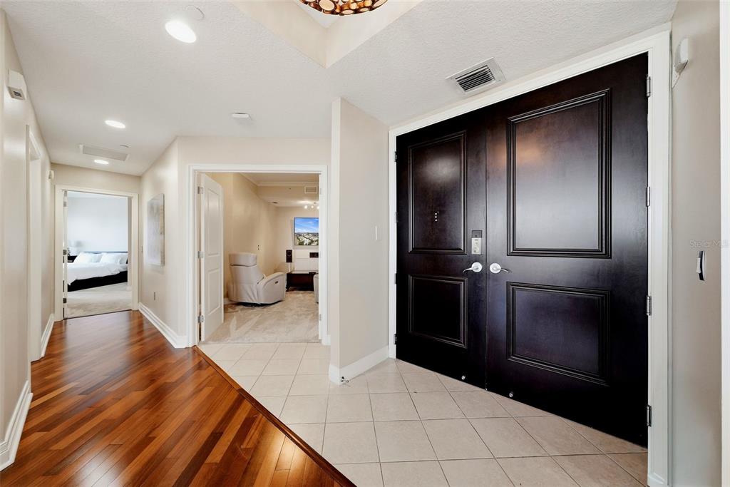 An entryway features dark double doors, tile flooring, and a hallway with hardwood floors — 449 SOUTH  12TH UNIT 2301, TAMPA, FL