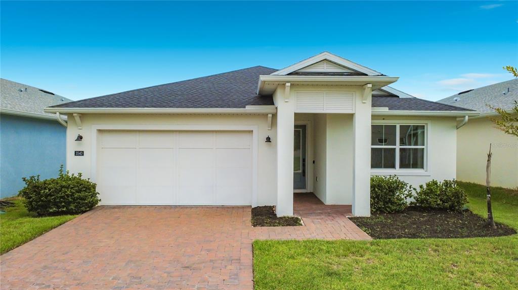 A hallway with light wood flooring leads to a living area, a bedroom, and a bathroom — 3540 STONEBRIAR LANE, SANFORD, FL
